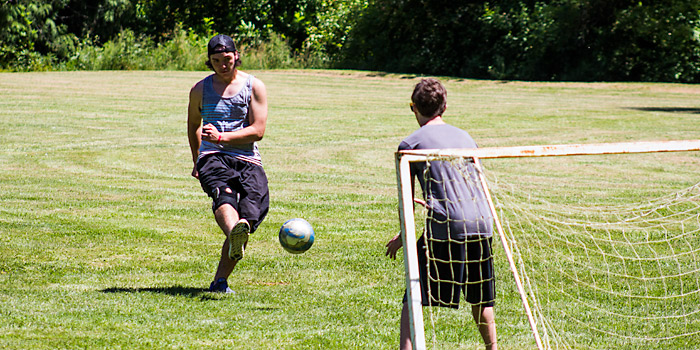 High School kids playing soccer in the Camp Yamhill Meadow