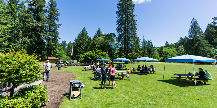 People gathered in the meadow to enjoy Camp Yamhill's Open House and BBQ