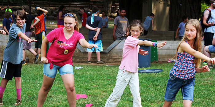 Campers at Camp Yamhill's 5th and 6th Grade Camp doing activities in the field.